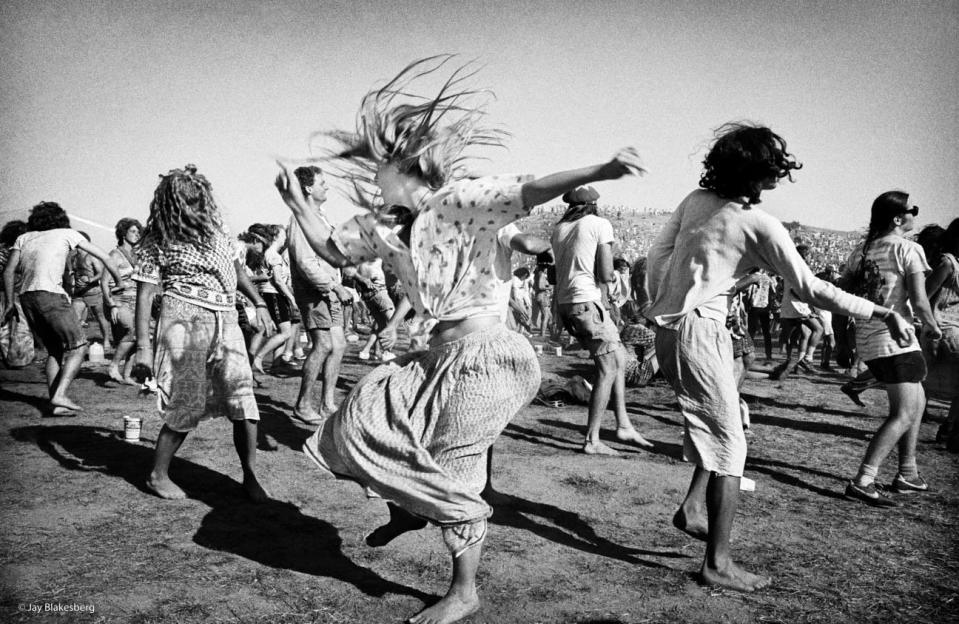 Feeling the spirit, some young people dance on a lawn. (credit: Jay Blakesberg)