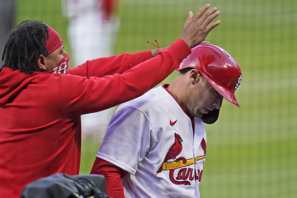 St. Louis Cardinals' Paul Goldschmidt, right, is congratulated by teammate Carlos Martinez after hitting a solo home run during the first inning of a baseball game against the Washington Nationals Tuesday, April 13, 2021, in St. Louis. (AP Photo/Jeff Roberson)