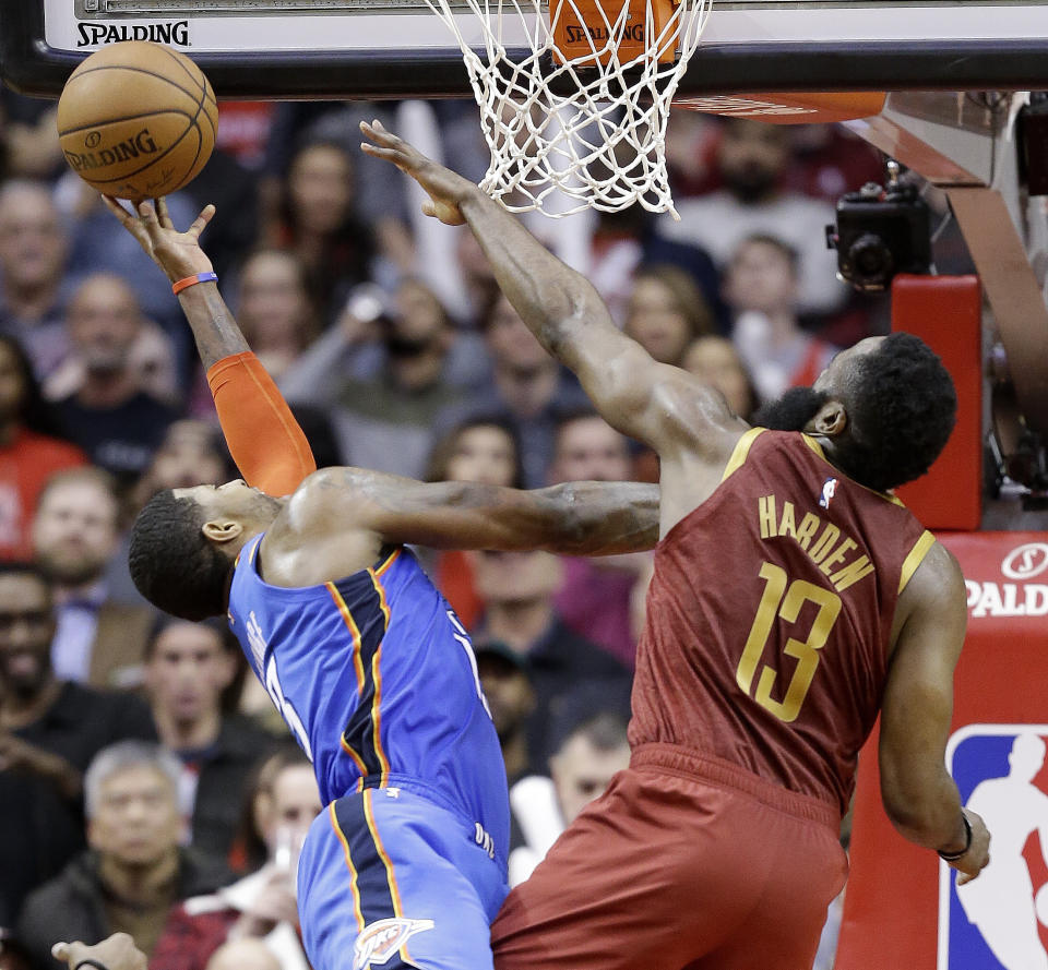 Oklahoma City Thunder forward Paul George, left, shoots as Houston Rockets guard James Harden defends during the second half of an NBA basketball game, Saturday, Feb. 9, 2019, in Houston. Oklahoma City won 117-112. (AP Photo/Eric Christian Smith)