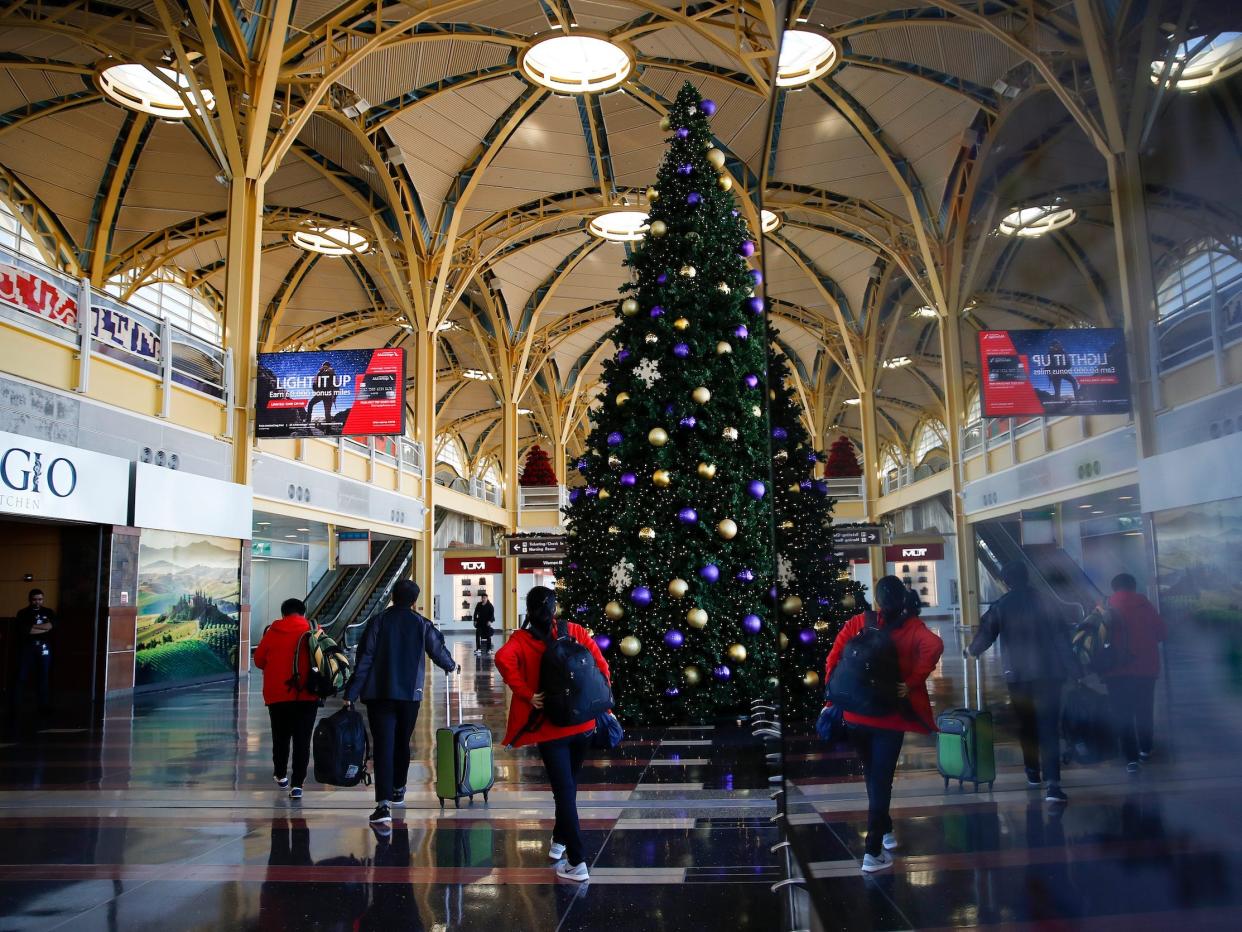 A Christmas tree towers over travelers at Ronald Reagan Washington National Airport in Arlington, Virginia.