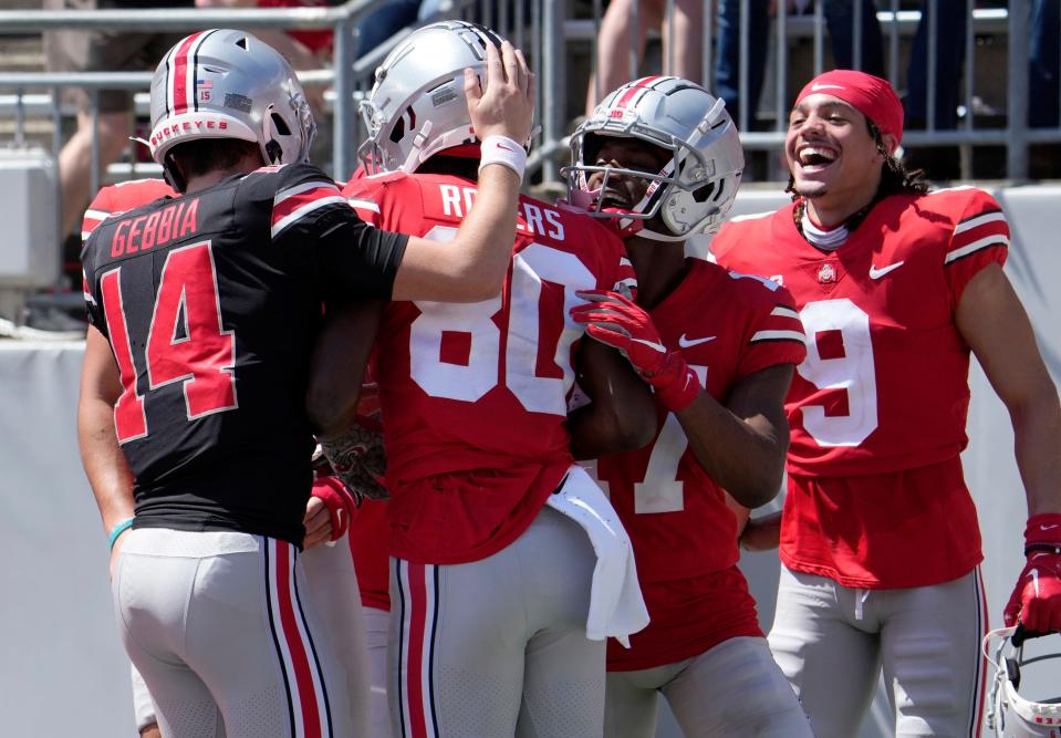 April 15, 2023; Columbus, Ohio, USA;  Quarterback Tristan Gebbia (14) and wide receiver Noah Rogers (80) celebrate after teaming up for a touchdown during the third quarter of the Ohio State spring football game Saturday at Ohio Stadium.Mandatory Credit: Barbara J. Perenic/Columbus Dispatch
