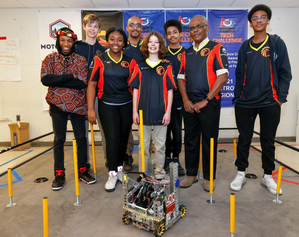 Some of the members of Detroit's Foreign Language Immersion And Cultural Studies School robotics team after practice on Friday, Feb. 10, 2023. Tyre Ramey, 13, left, Caleb Baker, 15, Tyneisha Powell, 13, lead robotics coach Leon Pryor, his son Leon Pryor, robotics coach Jean-Claude Quenum and Aslan Fleming, 13. The team qualified for the world robotics championship that happens in Houston in April. It is the first Detroit middle school to compete in it.