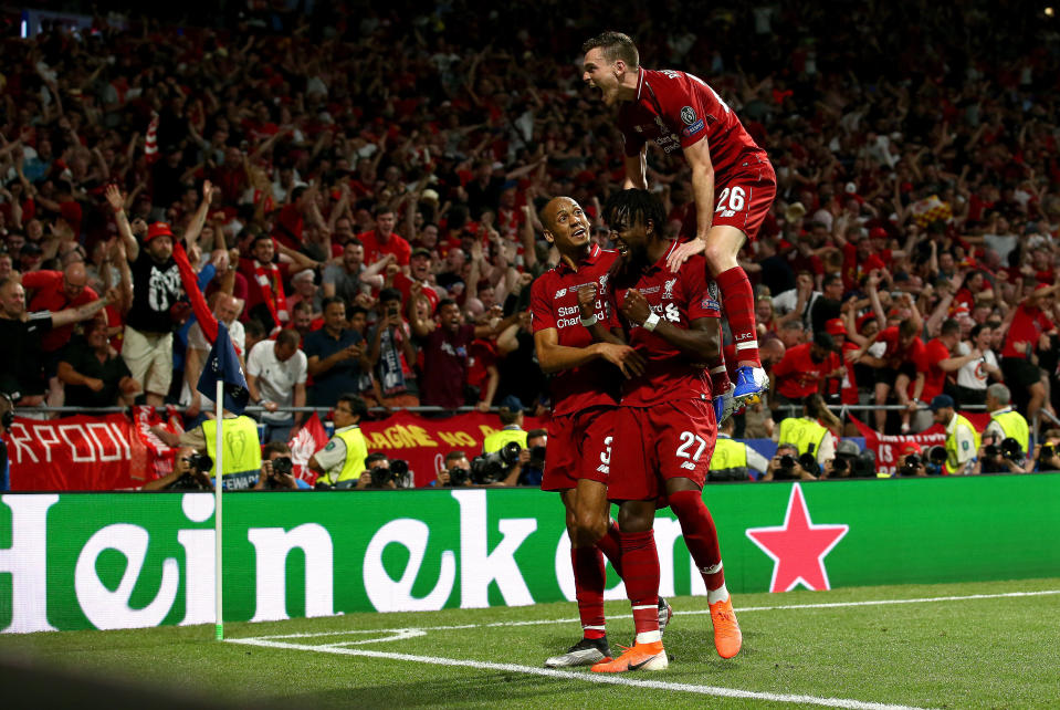 MADRID, SPAIN - JUNE 01: Divock Origi of Liverpool celebrates with teammates Fabinho and Andy Robertson after scoring his team's second goal during the UEFA Champions League Final between Tottenham Hotspur and Liverpool at Estadio Wanda Metropolitano on June 01, 2019 in Madrid, Spain. (Photo by Jan Kruger - UEFA/UEFA via Getty Images)