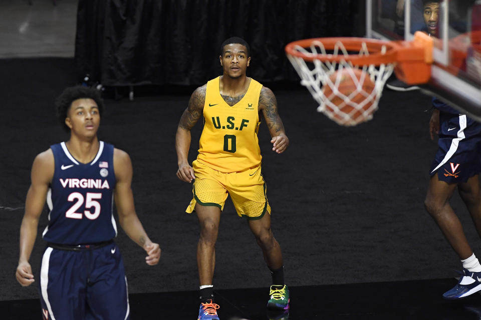 San Francisco's Khalil Shabazz, center, watches his 3-point basket go in against Virginia. (AP Photo/Jessica Hill)