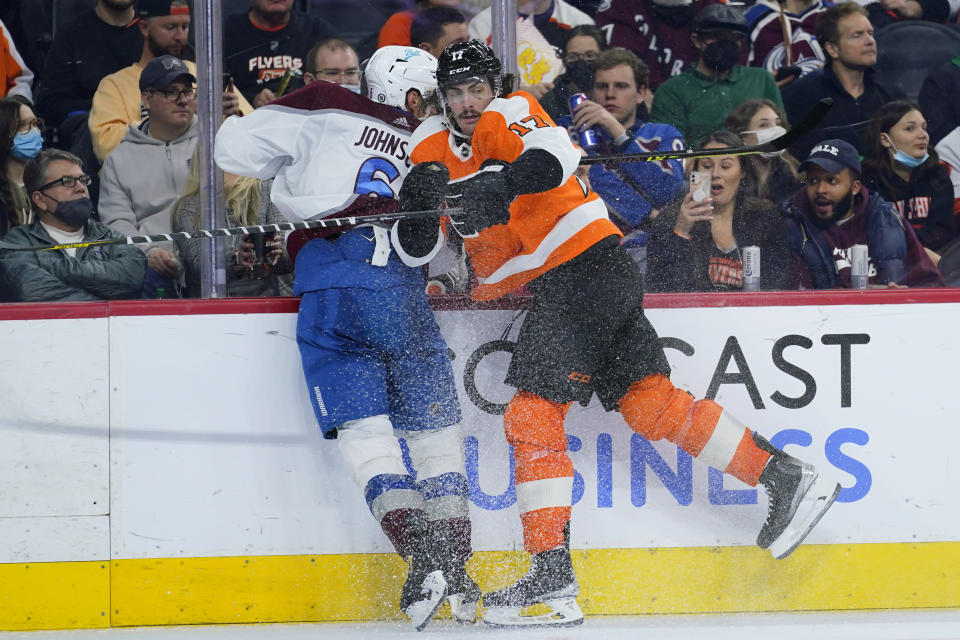 Philadelphia Flyers' Zack MacEwen, right, colides with Colorado Avalanche's Erik Johnson during the second period of an NHL hockey game, Monday, Dec. 6, 2021, in Philadelphia. (AP Photo/Matt Slocum)