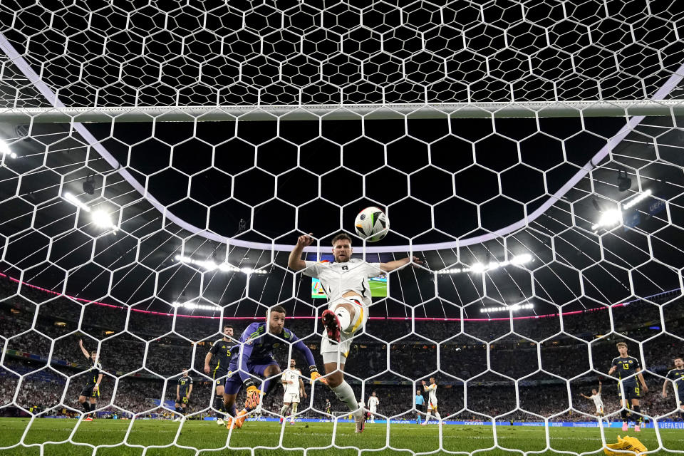 Germany's Niclas Fuellkrug, center, scores a disallowed goal during a Group A match between Germany and Scotland at the Euro 2024 soccer tournament in Munich, Germany, Friday, June 14, 2024. (AP Photo/Antonio Calanni)