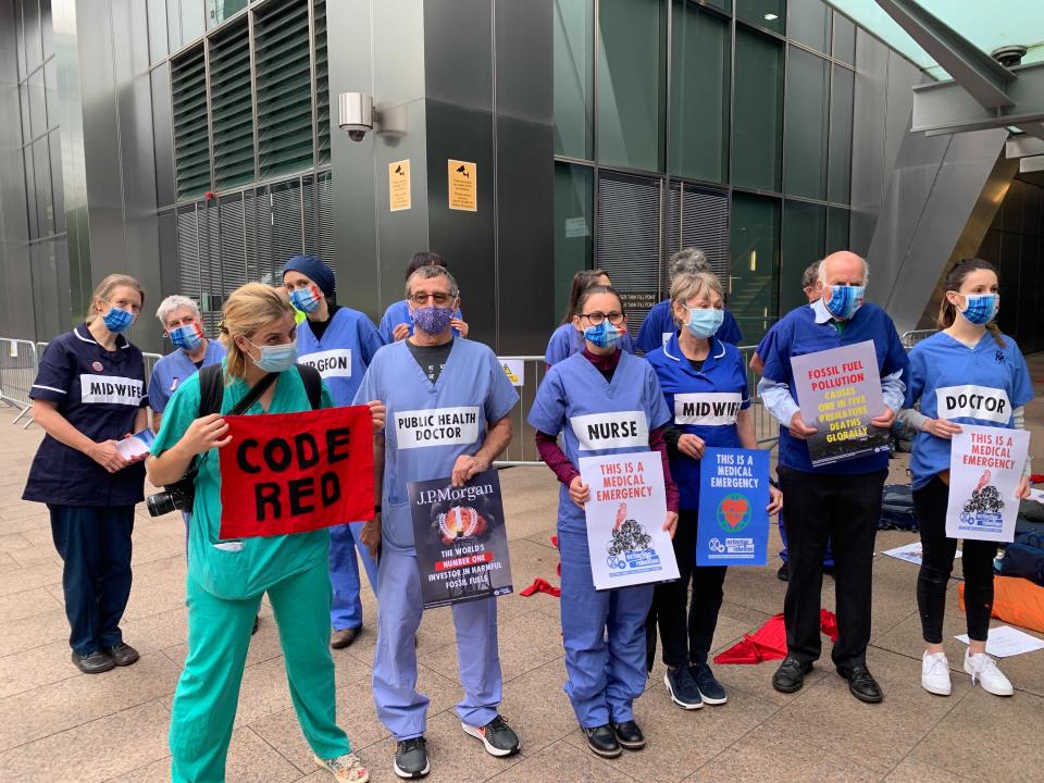 Protesters held banners saying ‘code red’ and ‘this is a medical emergency’ (The Independent)