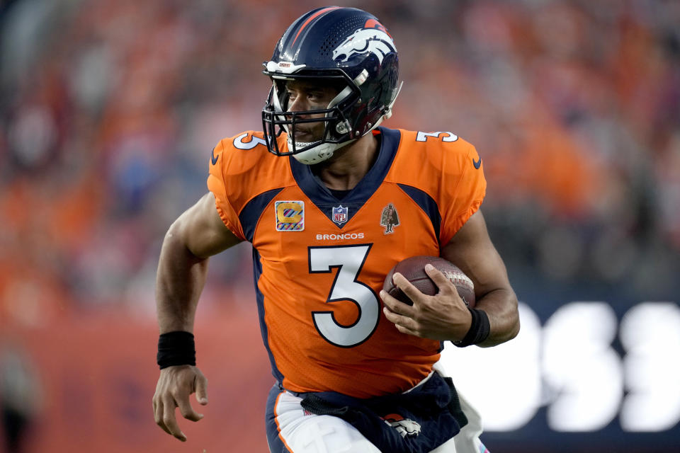 Denver Broncos quarterback Russell Wilson (3) scrambles against the Indianapolis Colts during the first half of an NFL football game, Thursday, Oct. 6, 2022, in Denver. (AP Photo/David Zalubowski)