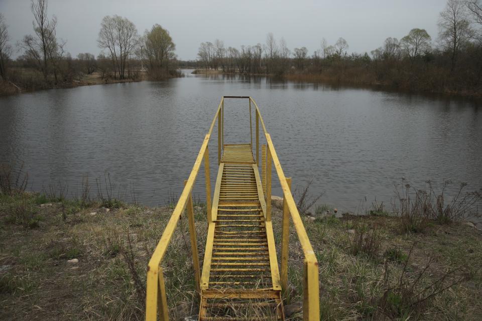 <p>A metal landing leads out to what was once a port for boats on the Pripyat River (Getty Images) </p>