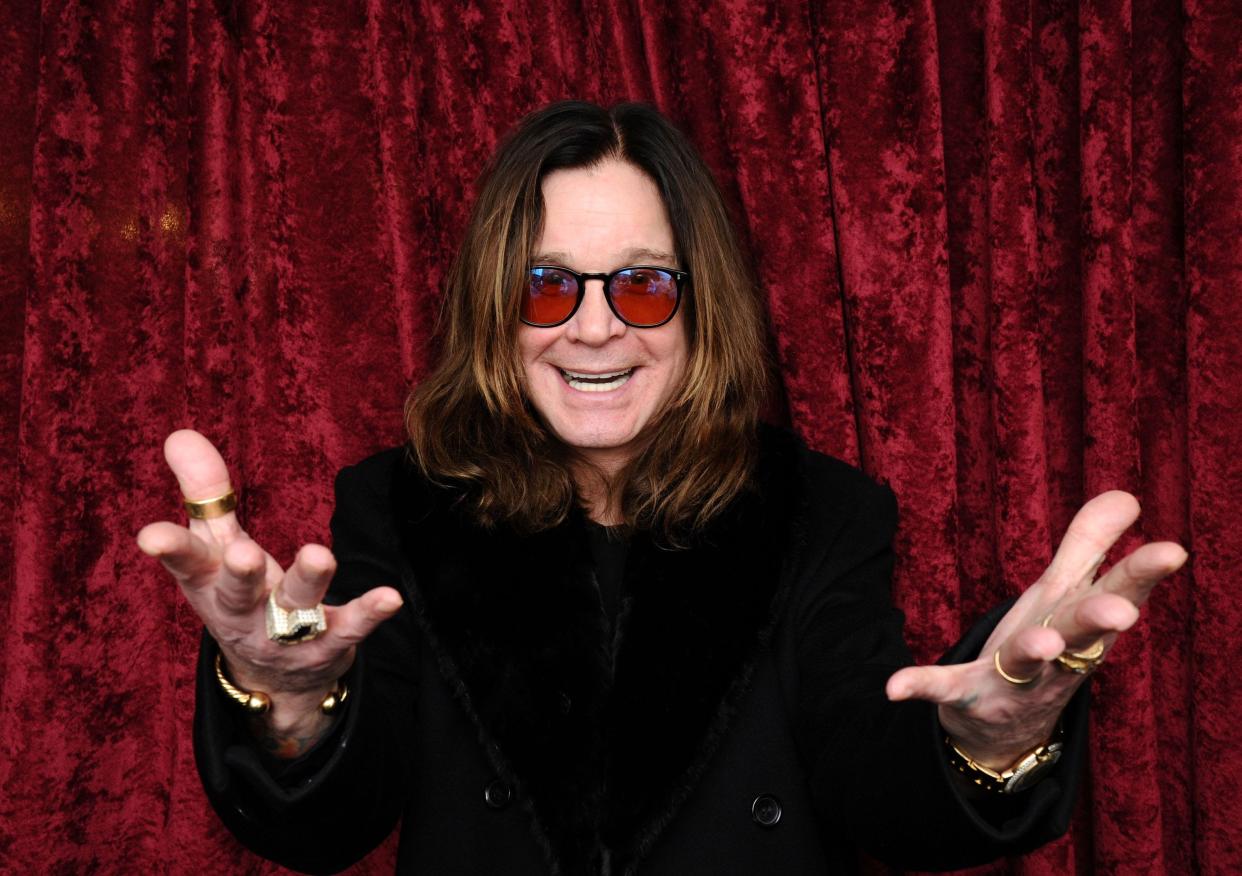 Ozzy Osbourne, hands outstretched, headshot. 
