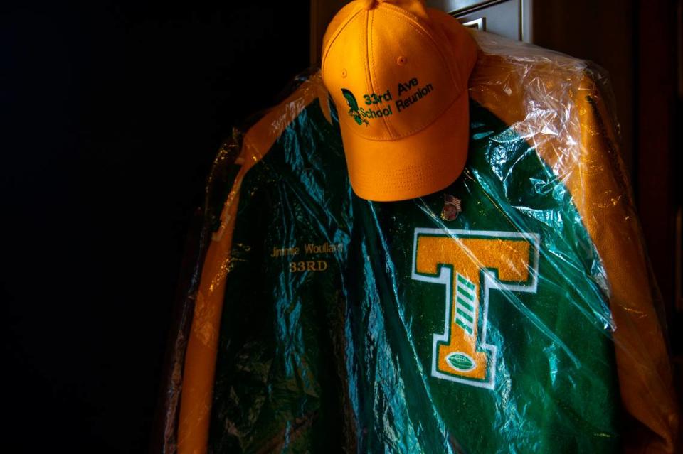 The letterman jacket of 33rd Ave. School alumnus Jimmie Woullard hangs in the East Biloxi Library on Saturday, July 31, 2021. Photos and objects from the 33rd Ave. School are being collected at the library for an exhibit.