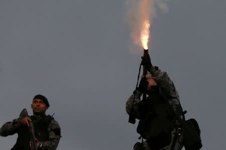 Riot policemen fire tear gas during a clash with demonstrators during a protest against a constitutional amendment, known as PEC 55, that limit public spending, in front of Brazil's National Congress in Brasilia, Brazil November 29, 2016. REUTERS/Adriano Machado