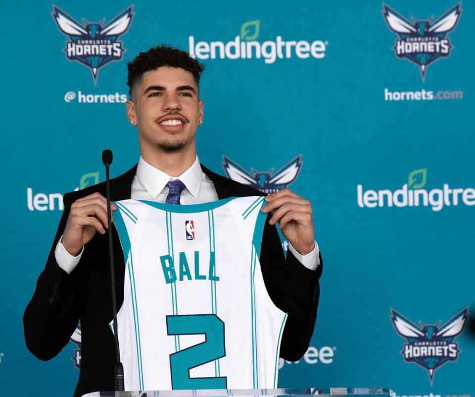 Charlotte Hornets 2020 first round draft pick LaMelo Ball holds up his jersey during a press conference outside the Spectrum Center on Friday.