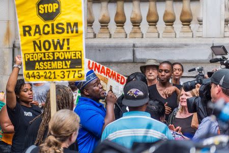 Activist C.D. Witherspoon speaks to protestors during pretrial motions for six police officers charged in connection with the death of Freddie Gray in Baltimore, Maryland September 10, 2015. REUTERS/Bryan Woolston