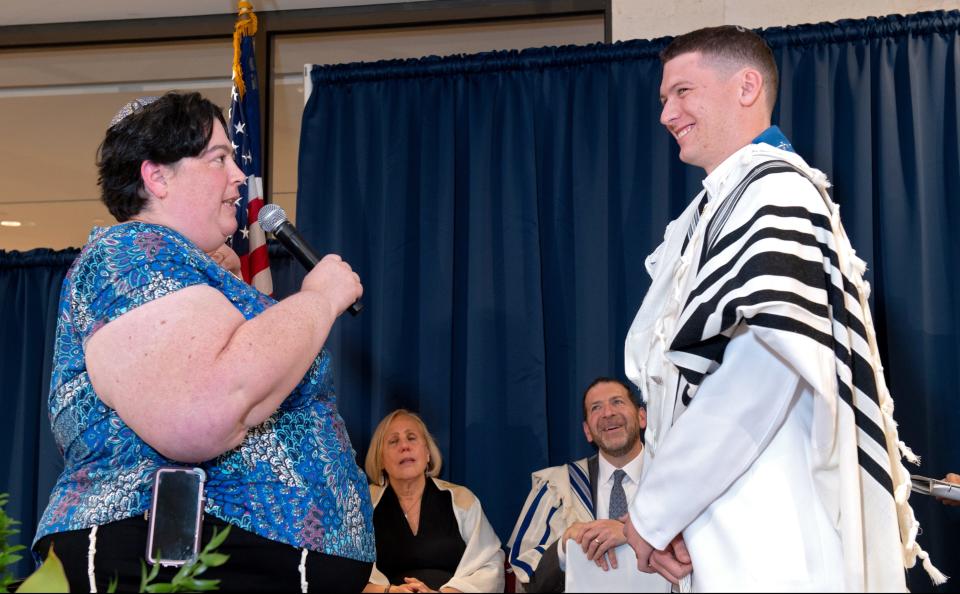 Rabbi Abby Jacobson, spiritual leader of Emanuel Synagogue, speaks to Alex Hamilton at his 2023 rabbinical ordination ceremony at the Jewish Theological Seminary in New York City.