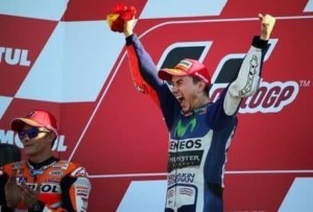 Spanish new World Champion Yamaha MotoGP rider Jorge Lorenzo (R) celebrates next to Honda rider Marc Marquez of Spain after winning the Valencia Motorcycle Grand Prix at the Ricardo Tormo racetrack in Cheste, near Valencia, November 8, 2015. REUTERS/Heino Kalis