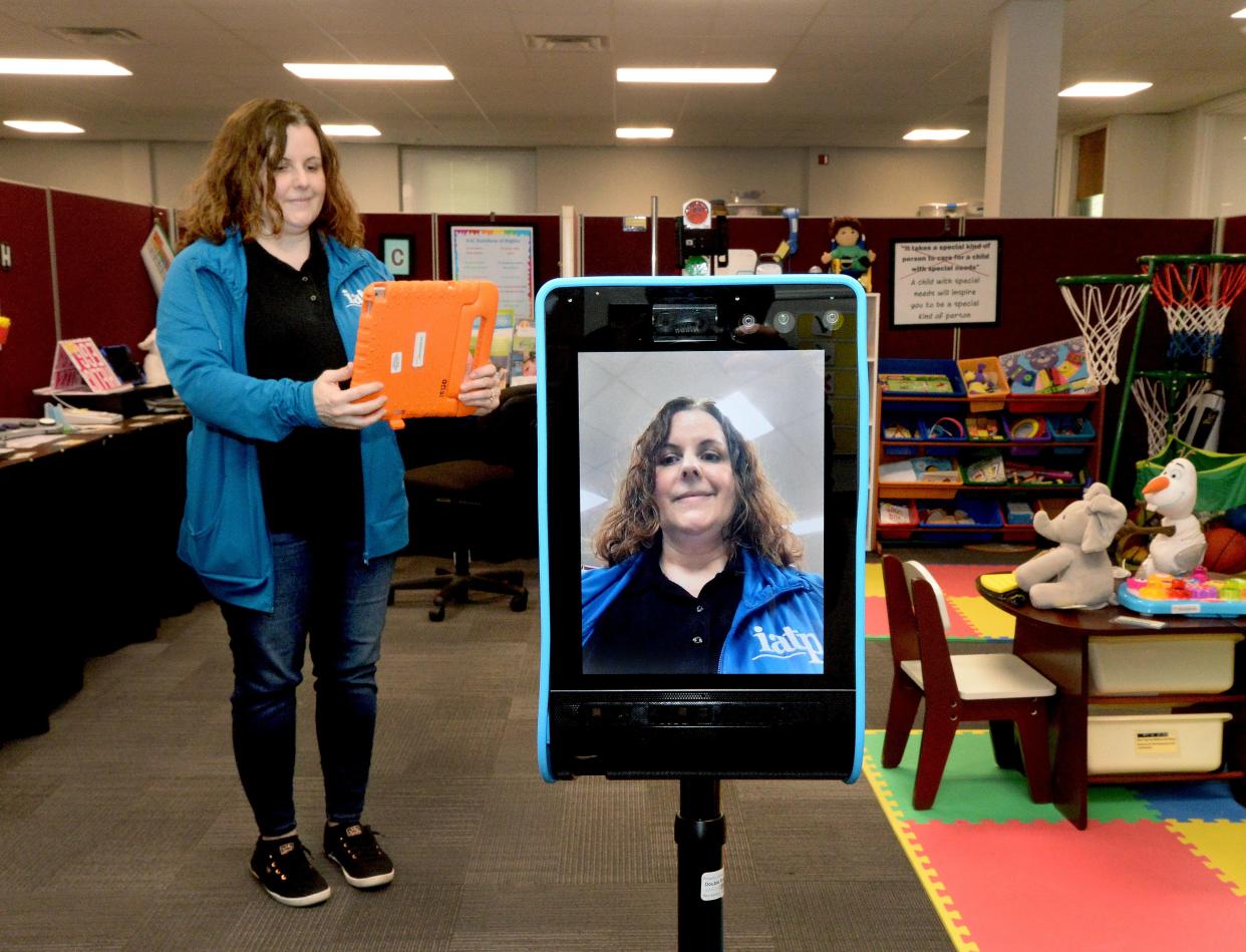 Illinois Assistive Technology Program employee Robin Richard uses an iPad to guide the Double Robotics Telepresence Robot during a demonstration at the center last week. The robot consists of a base with wheels, camera, speakers, microphones and a monitor, remotely controlled. This enables the user to be physically and socially present in a remote environment. IATP, a statewide program, will be moving into the former Vibra Hospital late this summer.