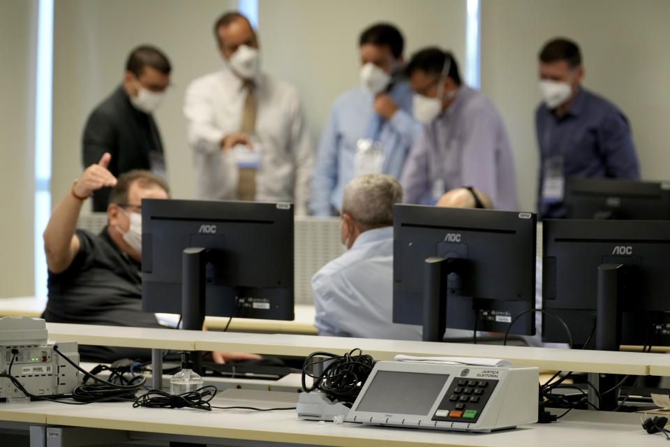 FILE - Analysts test the electronic voting system at the Supreme Electoral Court headquarters in Brasilia, Brazil, May 13, 2022. More than 20 would-be hackers gathered in the Brazilian electoral authority’s headquarters with the mission to infiltrate the nation’s voting system ahead of a hotly anticipated race in October. (AP Photo/Eraldo Peres, File)