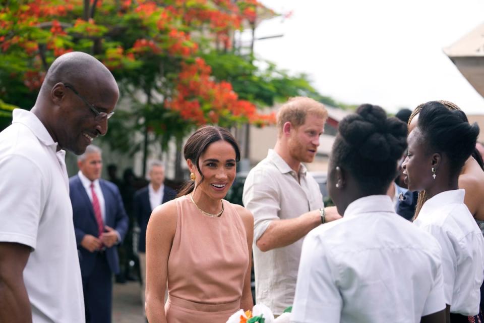 Prince Harry and Meghan meet children at the Lights Academy in Abuja (AP)