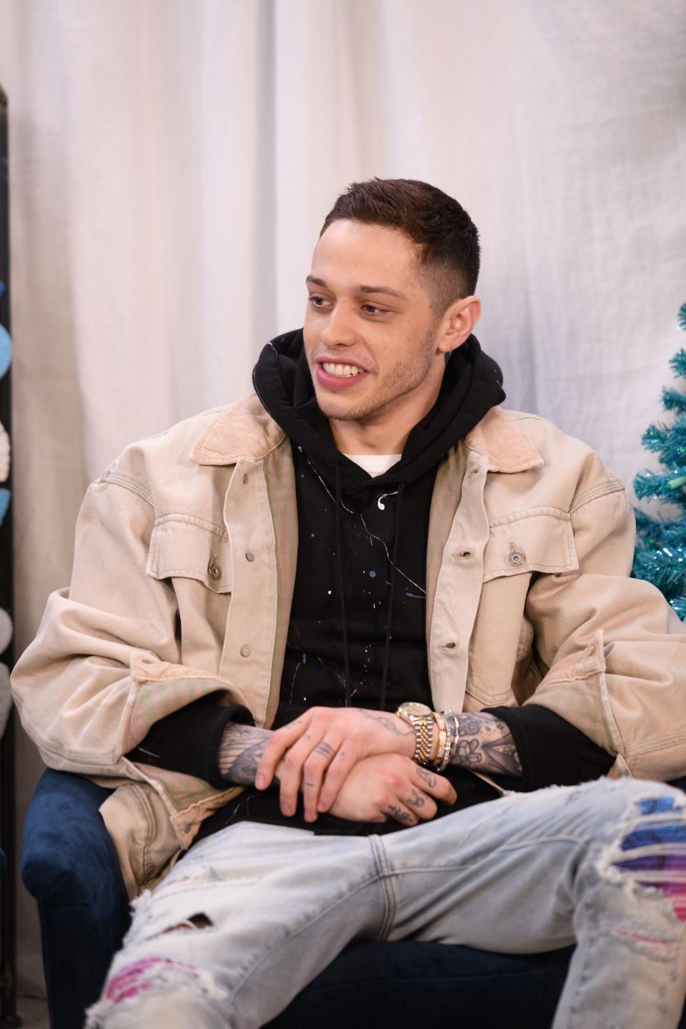 Pete Davidson has a cute smile on his face as he is caught on camera in denim jacket and pants to match.