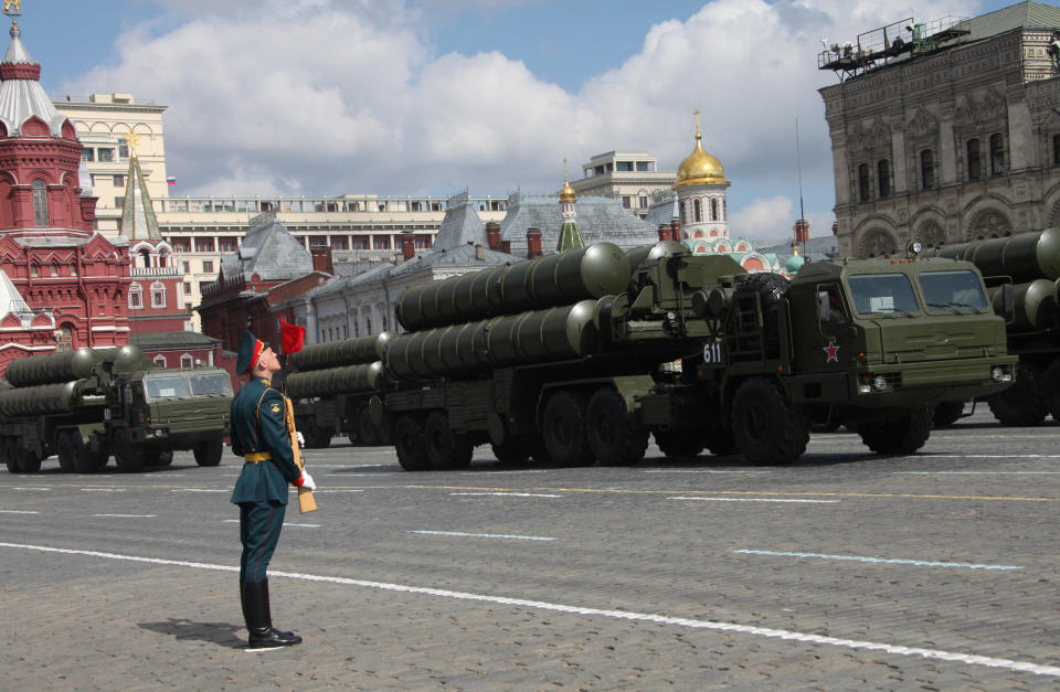 A Russian soldier stands to attention on Red Square as the mobile theater ballistic missile system rolls past.