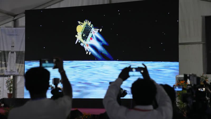 Journalists film the live telecast of spacecraft Chandrayaan-3 landing on the moon at ISRO’s Telemetry, Tracking and Command Network facility in Bengaluru, India, Wednesday, Aug. 23, 2023. The Chandrayaan-3 successfully made a soft landing on the lunar south pole.