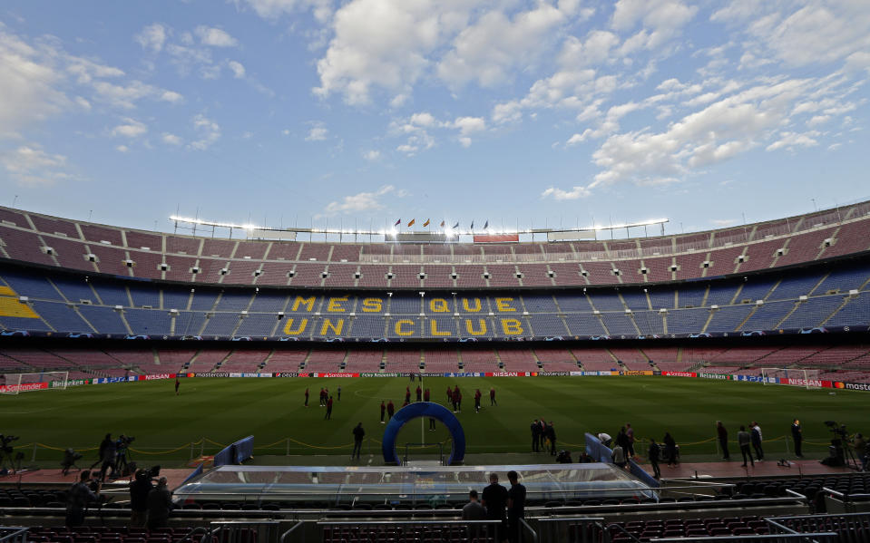 Liverpool's players inspect the pitch at the Camp Nou stadium in Barcelona, Spain, Tuesday, April 30, 2019. FC Barcelona will play against Liverpool in a first leg semifinal Champions League soccer match on Wednesday, May 1. (AP Photo/Manu Fernandez)