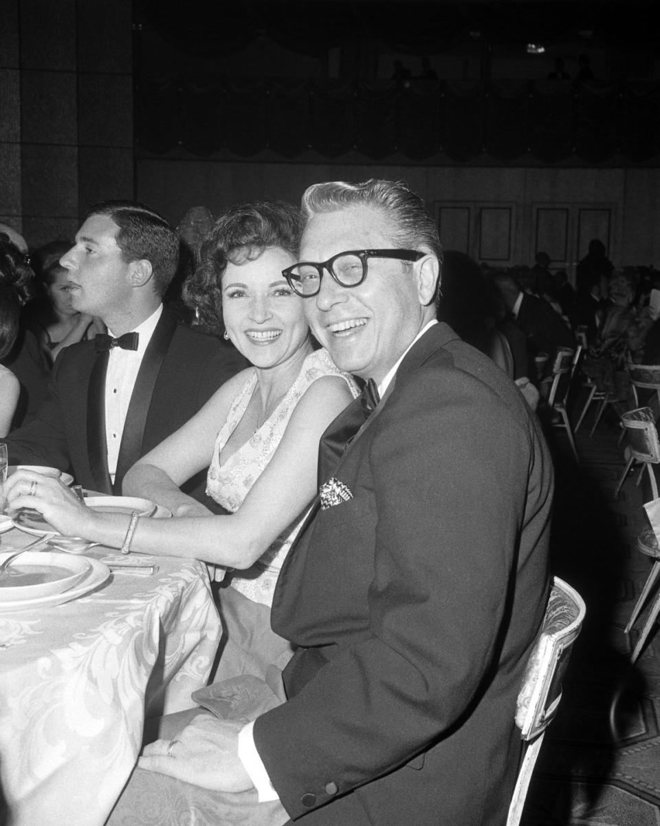 <p>Actress Betty White and her husband, television personality Allen Ludden, flash a smile at the camera as they enjoy the ceremony at the Hollywood Palladium. At the time, White was a frequent guest on many game shows, including <em>What's My Line?</em>, <em>I've Got a Secret</em>, and <em>To Tell the Truth</em>. </p>