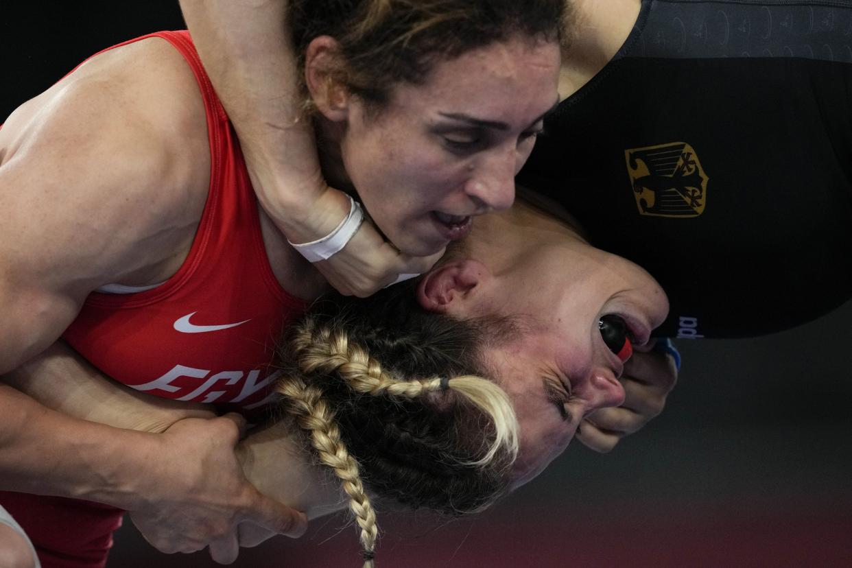 Germany's Anna Carmen Schell, right, reacts during her battle against Egypt's Enas Ahmed at the women's 68kg freestyle wrestling match at the 2020 Summer Olympics, Monday, Aug. 2, 2021, in Chiba, Japan.