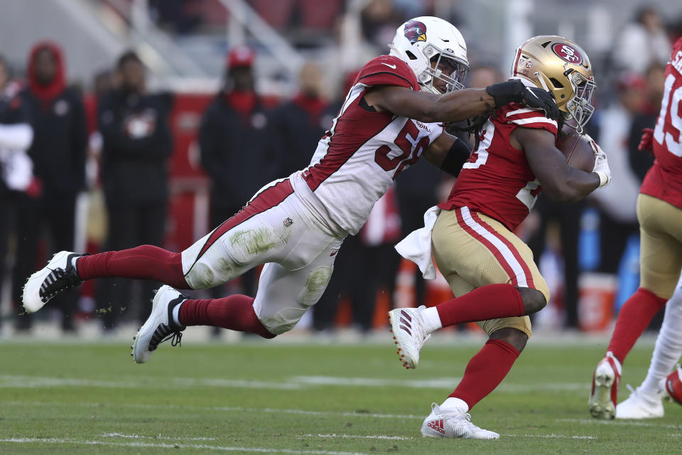 Arizona Cardinals middle linebacker Jordan Hicks, left, tackles San Francisco 49ers running back JaMycal Hasty during the second half of an NFL football game in Santa Clara, Calif., Sunday, Nov. 7, 2021. (AP Photo/Jed Jacobsohn)