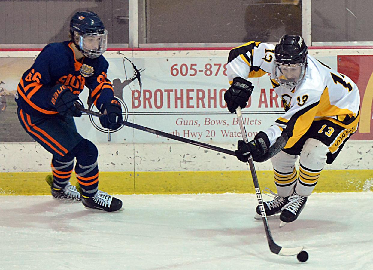 Tommy Foley of the Watertown Lakers controls the puck against Nathan Renken of the Sioux Falls West Flyers during a South Dakota Amateur Hockey Association varsity boys game on Friday, Dec. 1, 2023 in the Maas Ice Arena.