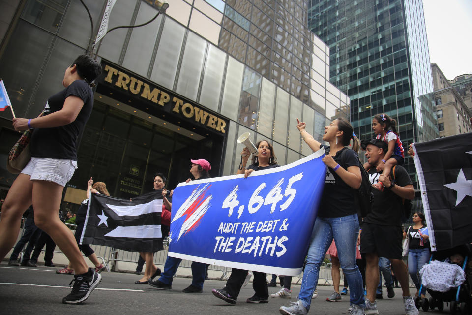 Puerto Rico Day Parade participants in 2018 turn their attention to Trump Tower as they march behind a banner in protest, marking "4,645" deaths in the aftermath of hurricane Maria on the island and the Trump's administration emergency response. (Photo: Bebeto Matthews/AP)