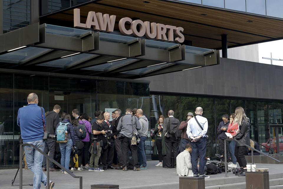 Members of the media wait outside the district court building as Tarrant made his first appearance on Saturday. Source: AAP