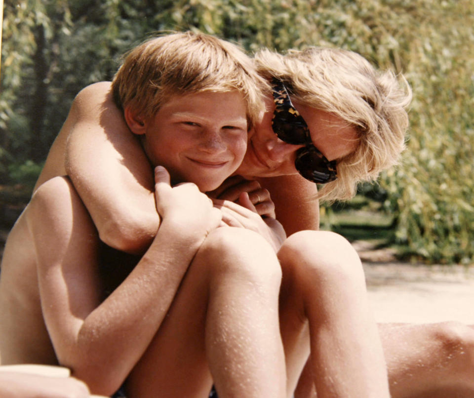 Princess Diana poses for a photo with Prince Harry on holiday.