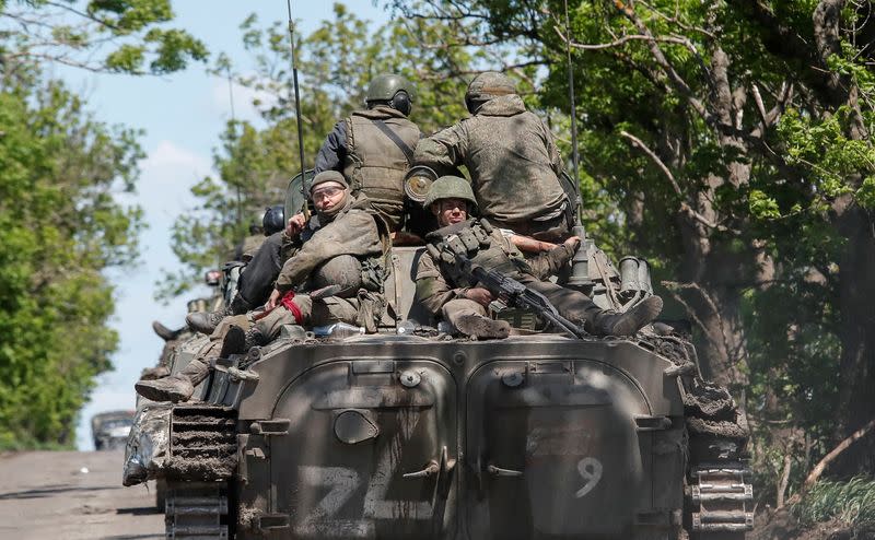 A convoy of pro-Russian troops drives along a road near Mariupol