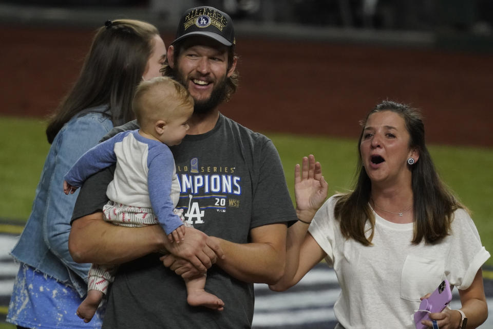 Los Angeles Dodgers pitcher Clayton Kershaw celebrates with his family after defeating the Tampa Bay Rays 3-1 to win the baseball World Series in Game 6 Tuesday, Oct. 27, 2020, in Arlington, Texas. (AP Photo/Tony Gutierrez)