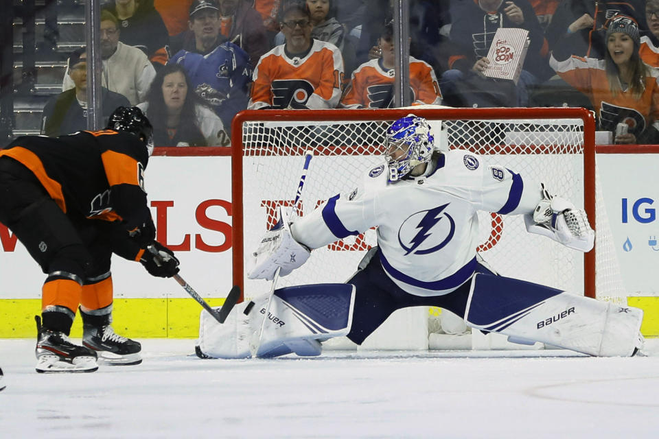 Tampa Bay Lightning's Andrei Vasilevskiy, right, blocks a shot by Philadelphia Flyers' Travis Sanheim during the third period of an NHL hockey game, Saturday, Jan. 11, 2020, in Philadelphia. (AP Photo/Matt Slocum)