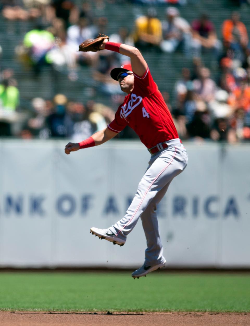Jun 26, 2022; San Francisco, California, USA; Cincinnati Reds shortstop Matt Reynolds (4) makes a leaping catch of a line drive by San Francisco Giants center fielder Austin Slater during the first inning at Oracle Park. Mandatory Credit: D. Ross Cameron-USA TODAY Sports