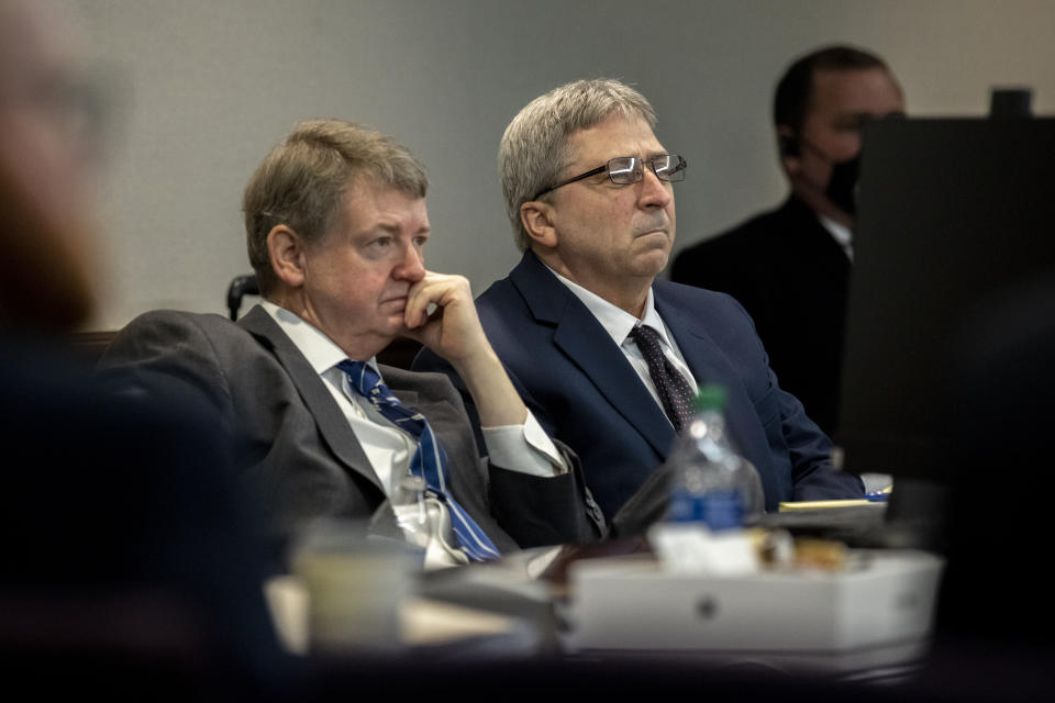 William "Roddie" Bryan, center, and his attorney Kevin Gough, left, listens to proceedings during a motion hearing at the Glynn County Courthouse, Thursday, Nov. 4, 2021, in Brunswick, Ga. Bryan, Greg McMichael and his son, Travis McMichael, are charged with the February 2021 slaying of 25-year-old Ahmaud Arbery. (AP Photo/Stephen B. Morton, Pool)