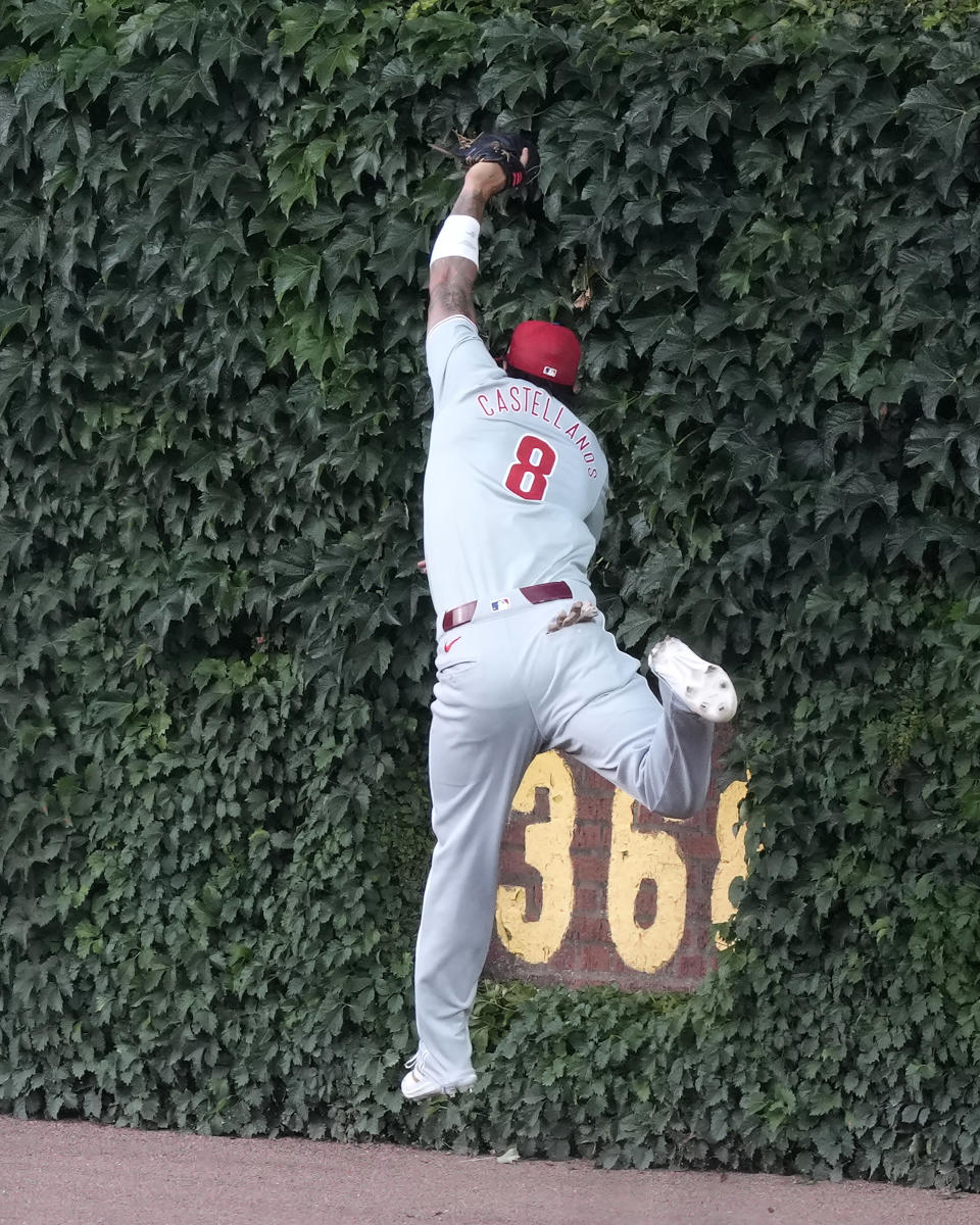 Philadelphia Phillies' Nick Castellanos catches a deep fly ball by Chicago Cubs' Cody Bellinger at the right field wall during the first inning of a baseball game Tuesday, July 2, 2024, in Chicago. (AP Photo/Charles Rex Arbogast)