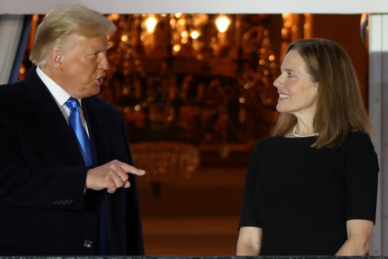 FILE PHOTO: U.S. President Trump speaks with Judge Barrett after she was sworn into her seat on the U.S. Supreme Court on the South Lawn of the White House in Washington