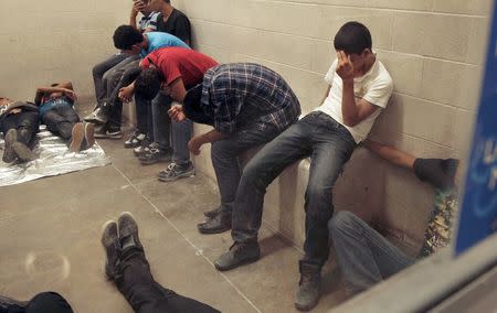 Immigrants who have been caught crossing the border illegally are housed inside the McAllen Border Patrol Station in McAllen, Texas, in this file photo taken July 15, 2014. The Obama administration on Thursday came under fire from Democratic presidential candidates and human rights groups for plans to intensify deportations of Central American migrants by rounding up undocumented families. REUTERS/ Rick Loomis/Pool/Files