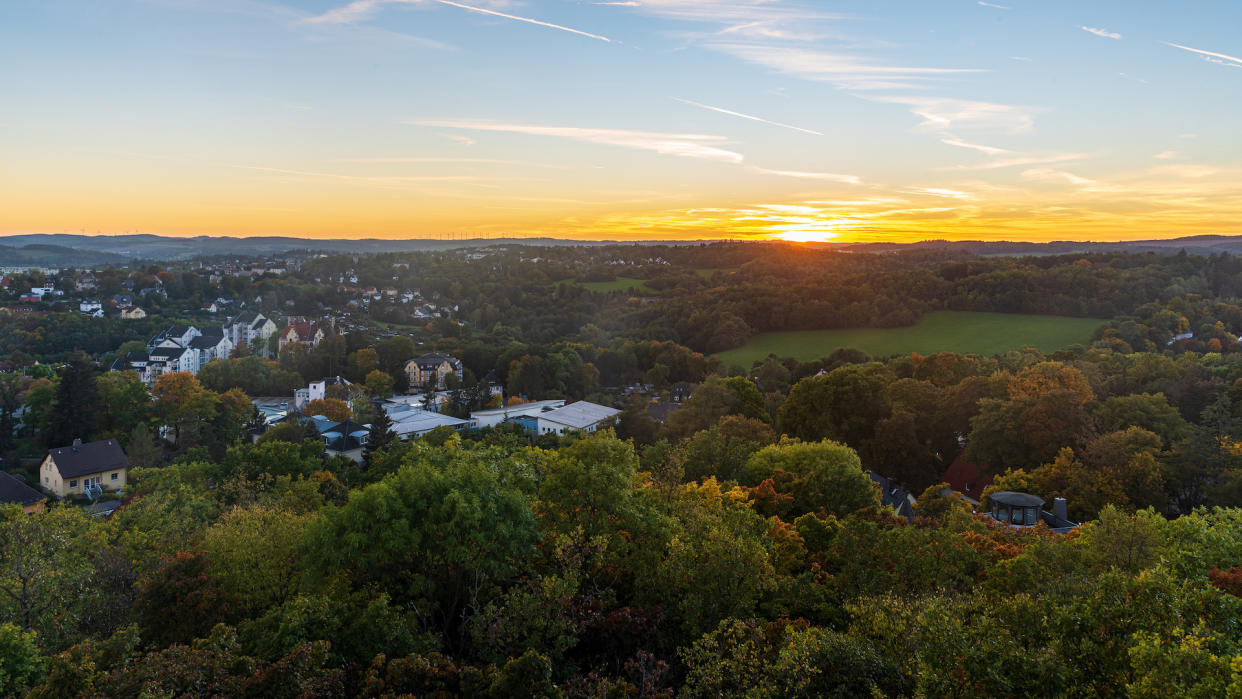  A photograph of an autumn sunset from Barenstein hill above Plauen city in Germany . 