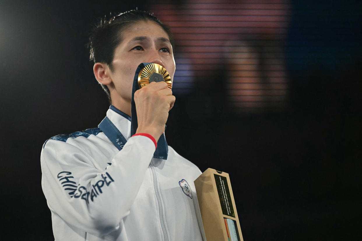 Gold medallist Taiwan's Lin Yu-ting celebrates on the podium during the medal ceremony for the women's 57kg final boxing category during the Paris 2024 Olympic Games at the Roland-Garros Stadium, in Paris on August 10, 2024. (Photo by Mauro PIMENTEL / AFP) (Photo by MAURO PIMENTEL/AFP via Getty Images)