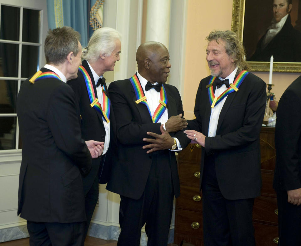 2012 Kennedy Center Honorees and members of Led Zeppelin John Paul Jones, left, Jimmy Page, second from left, and Robert Plant, right, talk with fellow 2012 Kennedy Center Honoree Buddy Guy at the end of the State Department Dinner for the Kennedy Center Honors gala Saturday, Dec. 1, 2012 at the State Department in Washington. (AP Photo/Kevin Wolf)
