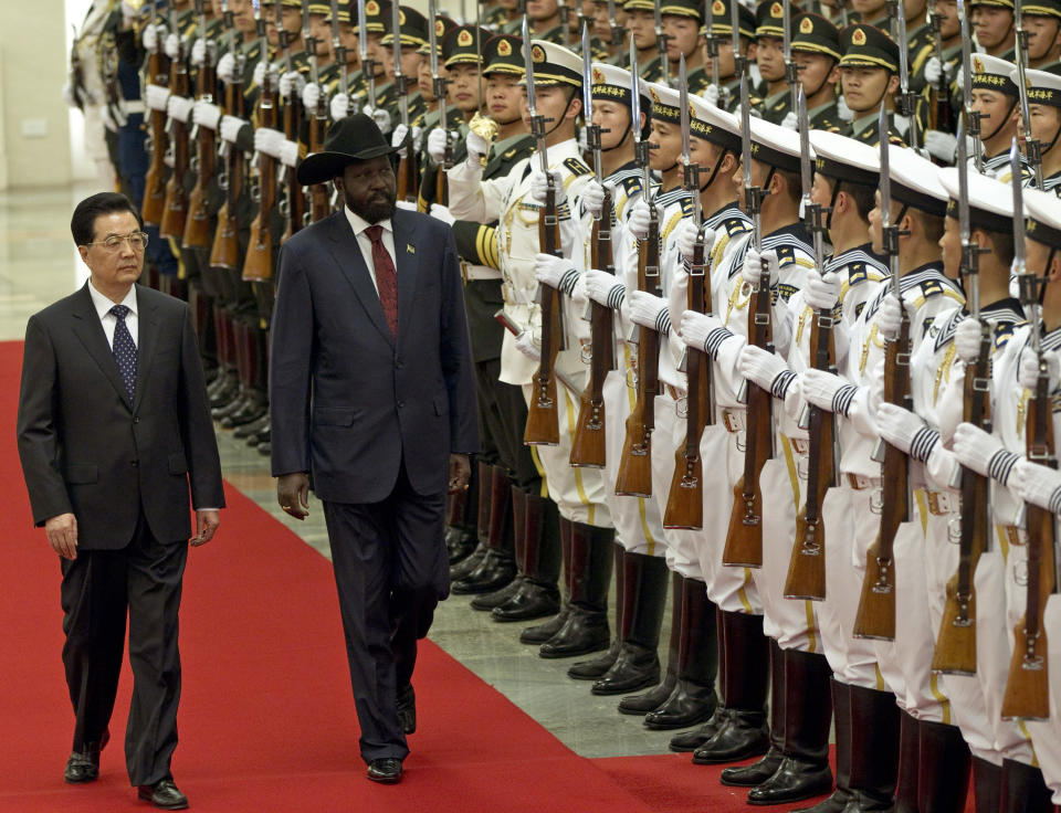 South Sudan's President Salva Kiir, right, reviews honor guard with Chinese President Hu Jintao, left, during a welcoming ceremony at the Great Hall of the People in Beijing, China, Tuesday, April 24, 2012. (AP Photo/Alexander F. Yuan)