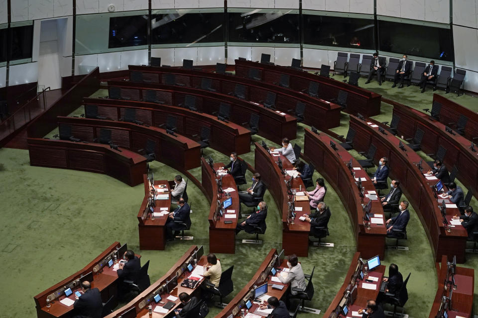 Empty seats of pro-democracy legislators, top, are seen as Hong Kong Chief Executive Carrie Lam delivers her policies at chamber of the Legislative Council in Hong Kong, Wednesday, Nov. 25, 2020. Lam said Wednesday that the city's new national security law has been “remarkably effective in restoring stability” after months of political unrest, and that bringing normalcy back to the political system is an urgent priority. (AP Photo/Kin Cheung)