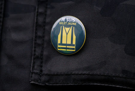 A protester wears a vest pin on which is read: "I am yellow vest" during a demonstration of the "yellow vests" movement in Nantes, France January 26, 2019. REUTERS/Stephane Mahe