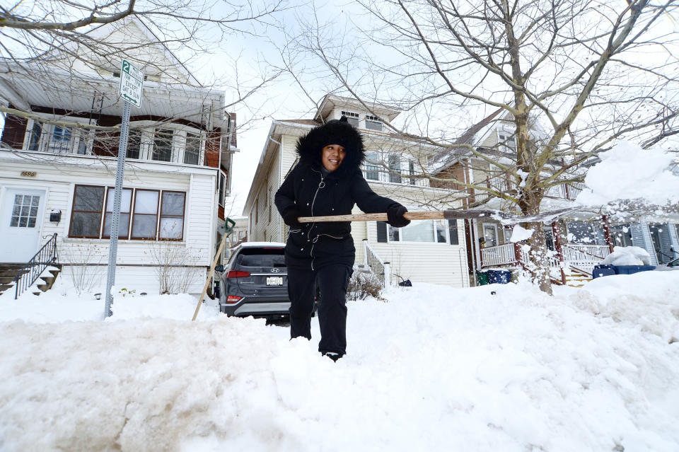 A woman clears snow from her driveway in Buffalo, N.Y. (John Normile / Getty Images file)