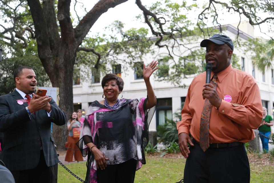 Georgia House Representative Edna Jackson waves as she stands between fellow Rep. Derek Mallow and Savannah Mayor Van Johnson during a rally in Johnson Square.